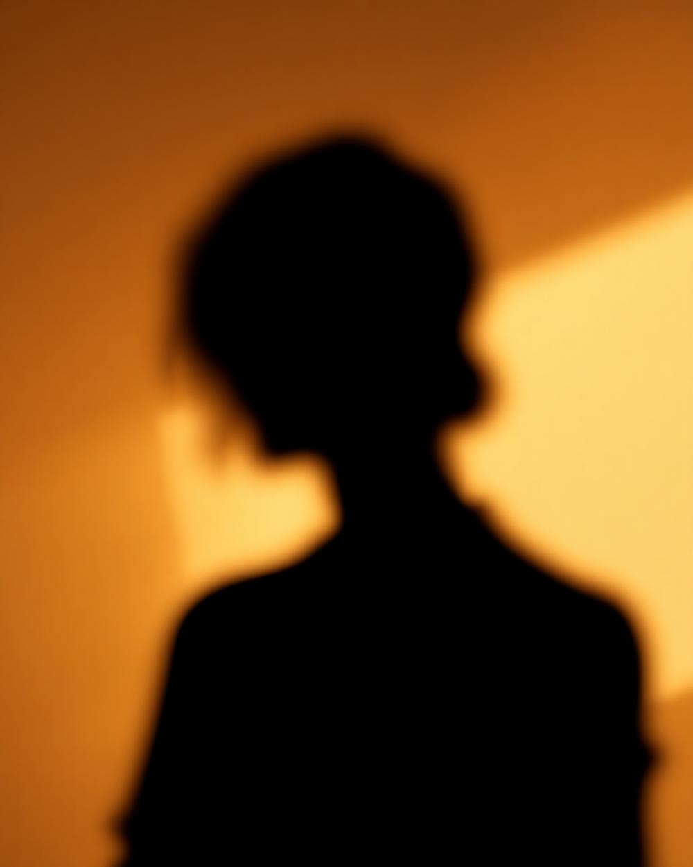 Editorial portrait placeholder, warm beige tones, final headshot pending.